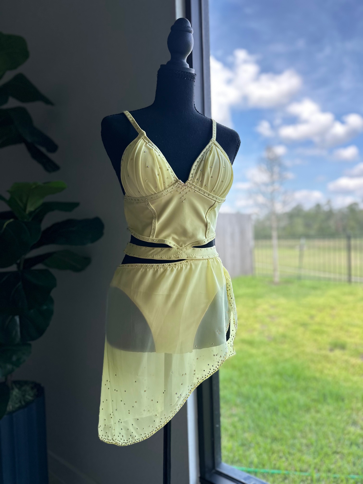 Custom lyrical costume in butter yellow with hand-set rhinestones