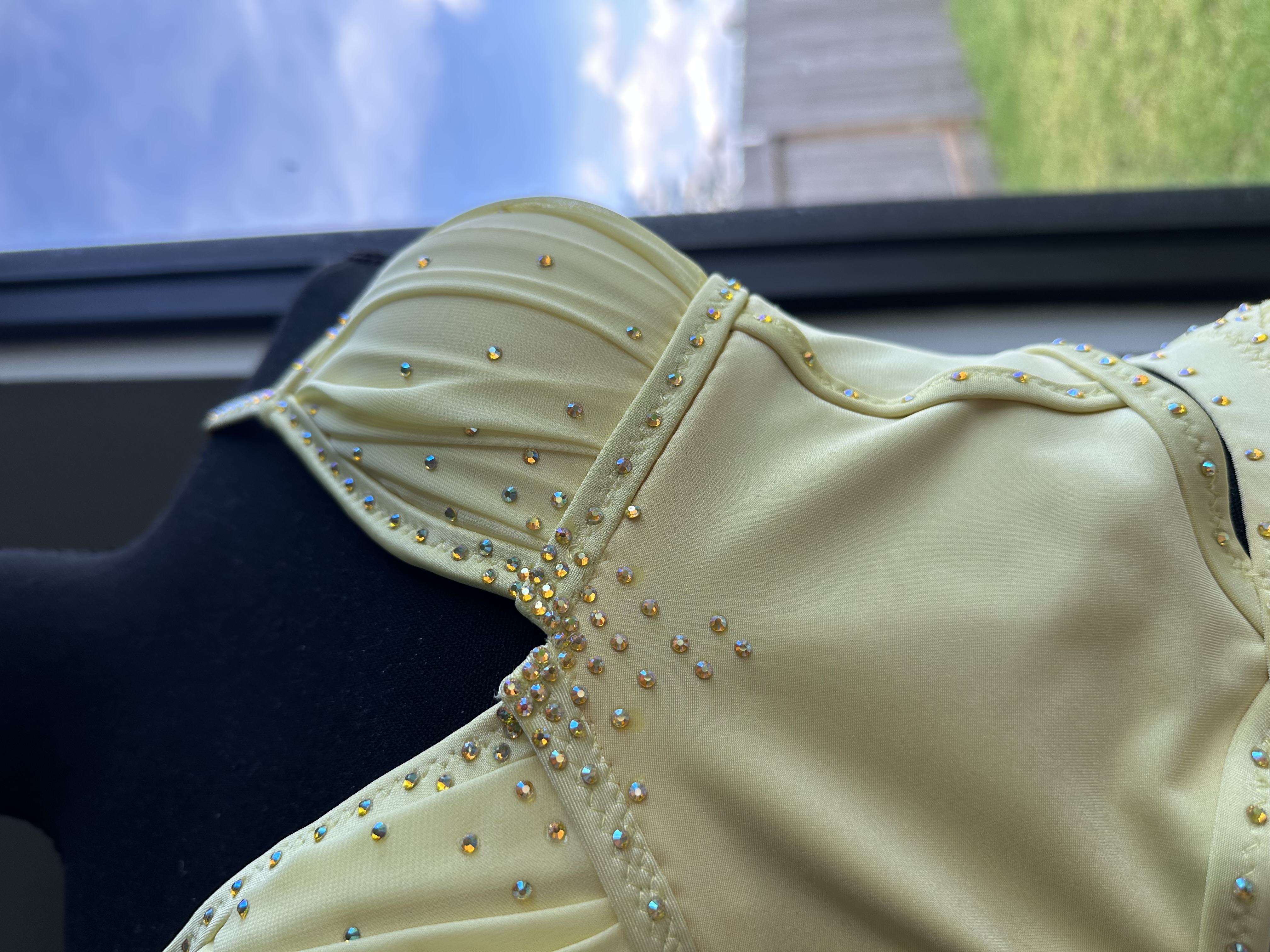 Close detail of ruched bodice and strap construction